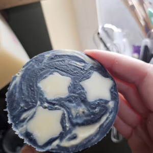 Dark blue indigo dyed soap with 3 stars representing the 3 of pentacles